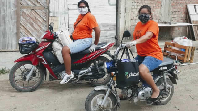 Two Kiya staff delivering aid on motorbikes image